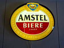 Enseigne lumineuse bar "AMSTEL Bière LAGER" ovale et bombée.