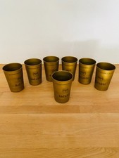 7 Gobelets en métal doré -