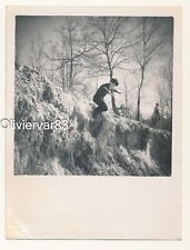 Vintage photo - boy jumping an embankment in woods