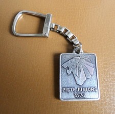 Ancien porte clé Peugeot métal Lion Piste Junior 104 Esso Police Prévention..