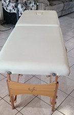 table de massage pliante beige de 1m80 par 65cm très bon état.