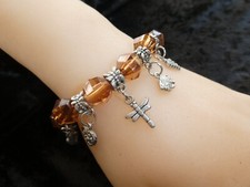 BRACELET GRIGRI PERLES  TRANSPARENTES ET  BRELOQUES        couleur ambre