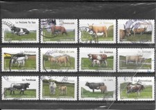 FRANCE 2014.LES VACHES DE NOS REGIONS.SERIE  DE 12 TIMBRES ADHESIFS CACHETS ROND