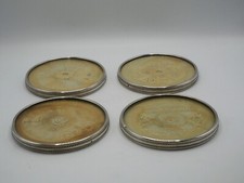 SUITE DE 4 DESSOUS DE BOUTEILLE EN ARGENT MASSIF POINCON MINERVE ET VERRE