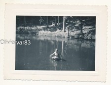 Vintage photo - woman in swimsuit bathing in a pond in woods