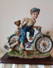 Vintage FigurineResin clock Statue of a Boy on His Bike Behind Him a Little Bear