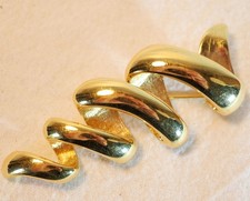 Bijou de créateur - Broche tourbillon plaqué or signée MONET REV25BRO001