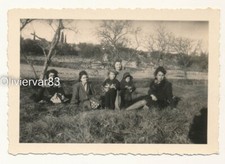 Vintage photo - 4 women and 2 girls sitting in a field, Winter trees