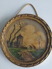 petite eau forte couleurs dans cadre rond doré paysage eglise maison