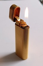 Briquet Cartier plaqué or luxe fonctionnel Cartier Trinity gold plated lighter