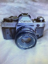 appareil photo canon ae-1 program. Offert:Flash+Filtres+sacoche+trépied+livres