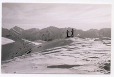 Vintage photo - 2 men with cameras on snowy mountain top