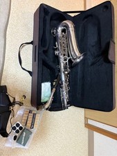 Silver saxophone with reed and