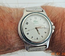 montre  LACOSTE  PILE NEUVE FONCTIONNE . ( le verre  a des rayures  )       