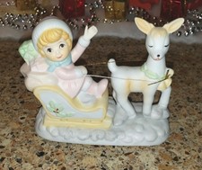 Vintage Girl in a Christmas Sled pulled by a Deer
